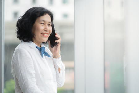 Asian middle business woman are calling for business success conceptの写真素材