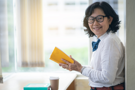 Asian woman are happy in libraryの写真素材