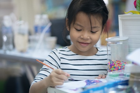 Asian girls are coloring happily in schoolの写真素材