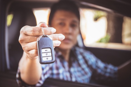 Close up of car key on human handの写真素材