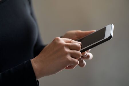 Woman hand holding smart phone.の写真素材