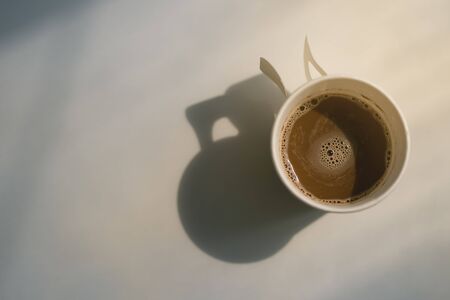 Hot coffee in a glass of paper With morning sunlightの写真素材