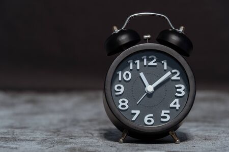 Black Alarm clock on concrete backgroundの写真素材