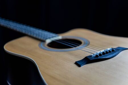 Guitar laying on a black background
