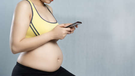 pregnancy using smart phone for social networkの写真素材