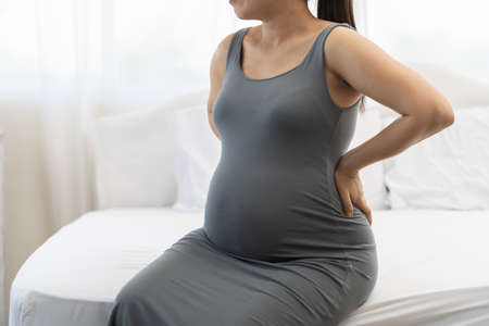 Pregnant women feel back pain and discomfort.の写真素材