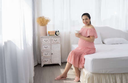 Beautiful Asian pregnant are drinking milk.の写真素材