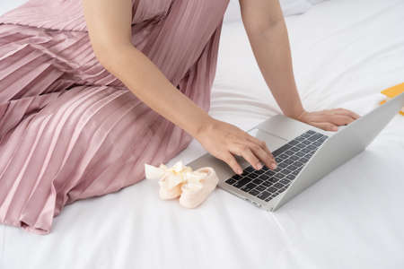 Pregnant women are shopping online for baby products.technology and ecommerce concept.の写真素材
