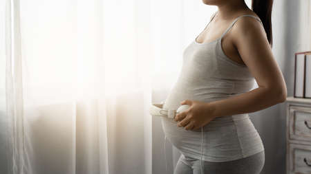 Pregnant women are listening to music for babyの写真素材
