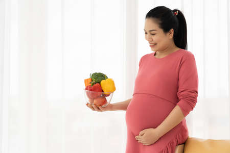 Pregnant women hold fruits and vegetables. Healthy food of pregnant womenの写真素材