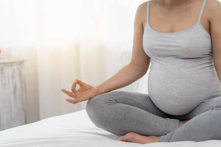 Pregnant women are doing yoga and meditation.の写真素材