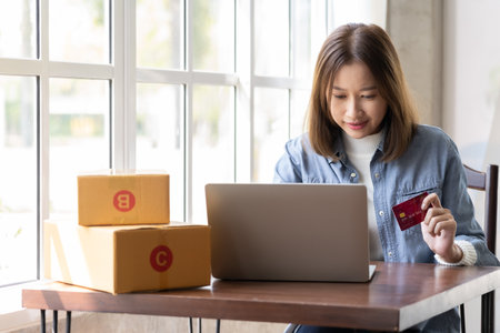Happy Asian woman shopping online and paying by credit card.technology and ecommerce conceptの写真素材