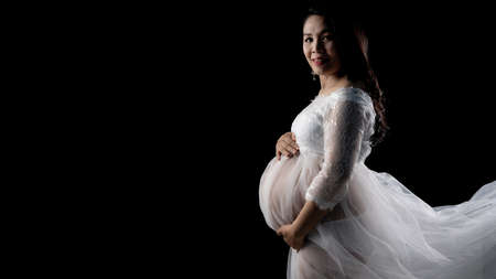 Beautiful Asian pregnant women on black backgroundの写真素材