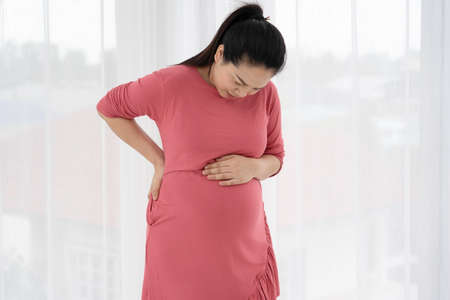 Pregnant women feel back pain and discomfort.の写真素材