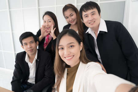 Asian business team taking selfie by smartphone,business people concept.の写真素材