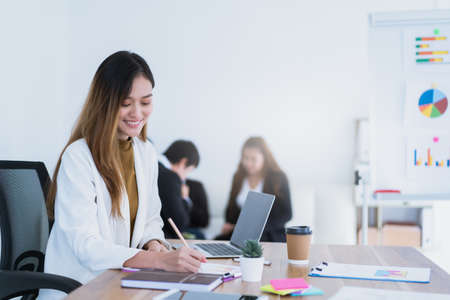 Yong Asian business woman working in modern company. Business concept and co-working spaceの写真素材
