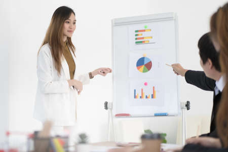 Beautiful Asian business woman are present business report in company, business concept.の写真素材