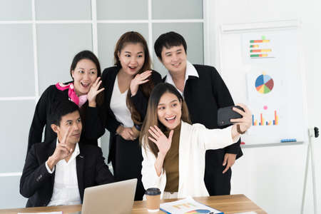 Asian business team taking selfie by smartphone,business people concept.