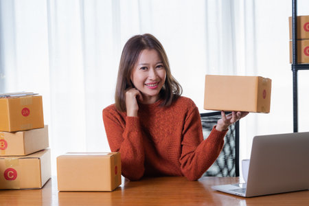 Beautiful Asian girl shop online are prepare for customer service with a smile.の写真素材
