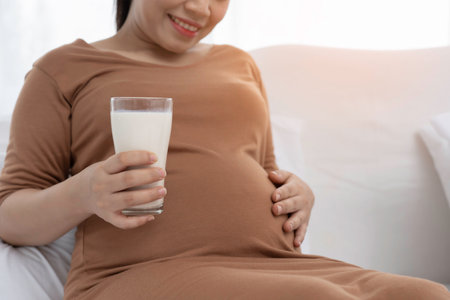 Beautiful Asian pregnant are drinking milk.の写真素材
