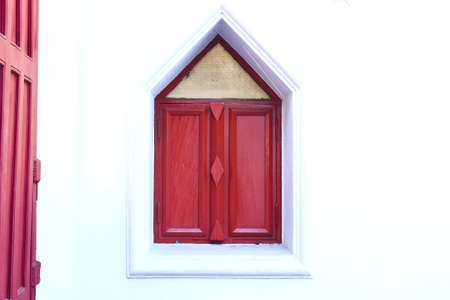 Wood windows on the ground wrapped in red and white colors stand taken in Samut Prakan province, Thailandの写真素材