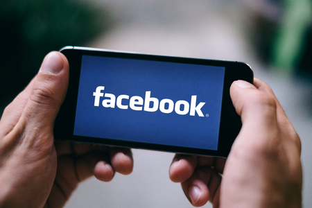 COLOGNE, GERMANY - MARCH 10, 2018: Closeup of iPhone screen with FACEBOOK LOGO or ICONのeditorial素材