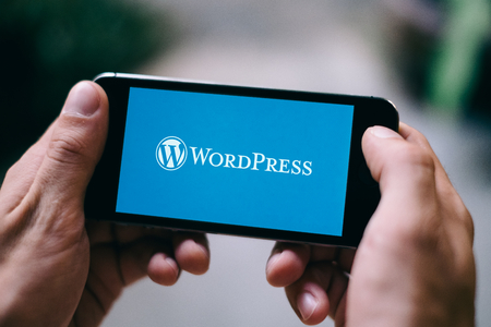 COLOGNE, GERMANY - MARCH 10, 2018: Closeup of iPhone screen showing Wordpress logoのeditorial素材