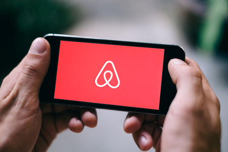 Closeup of iPhone screen with AIRBNB LOGOのeditorial素材