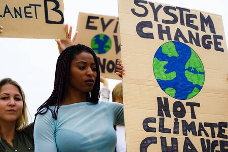 People protesting against multicultural opinion. Young people from diferent countries showing their ideology. Yought together under same defense - Focus face - Imageの写真素材