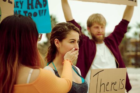 People with signs demanding "climate change" Justice and Climate. Group of demonstrators fight for climate change. Symbol of woman silenced by politics â Imageの写真素材