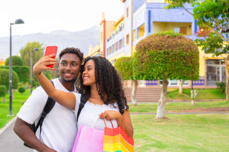 Capturing bright moments. Joyful young loving couple making selfie on camera. New technology trends and friendship concept.の写真素材