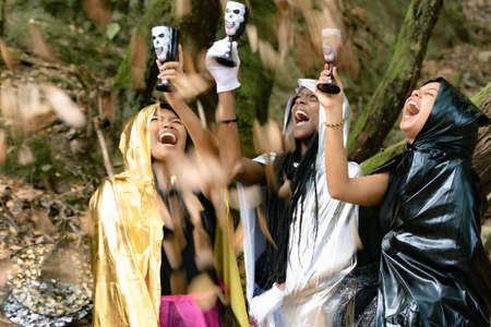 Three happy young women in witch halloween costumes. Halloween and carnival concept.