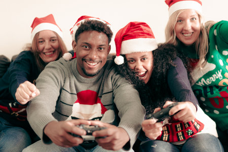 Millennial people having fun with video games console on christmas time. Family playing video games...