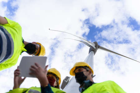 Engineer woman explaining being operated renewable energy with digital tablet. Concept of clean...