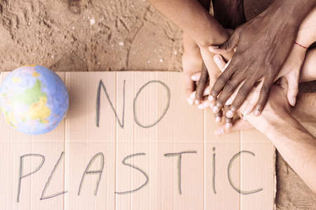 There is a sign that says "NO PLASTIC". Team ready to clean the world of the plastic. Ecology concept, recycle symbol, zone with no plastic.の写真素材