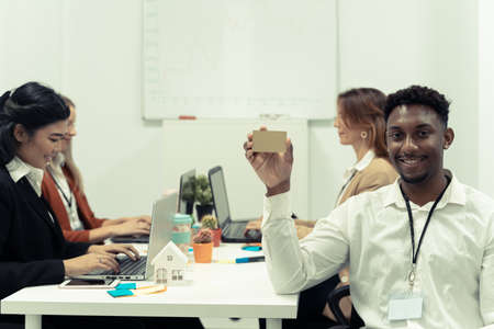 Business man with his staff, people group in background at modern office indoors. Work and school concept.の写真素材