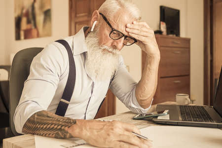Tired worker, headache, engineer working in house. Job and medicine concept.の写真素材