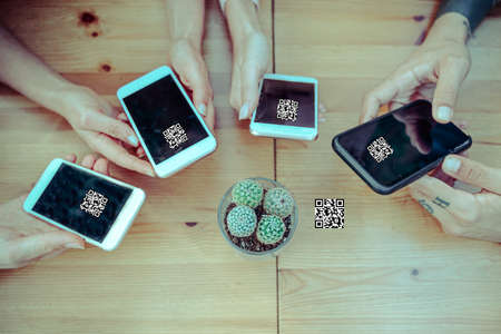 Group of friends watching smart mobile phones. Teenagers addiction to new technology trends. Concept of youth, tech, social and friendship.の写真素材