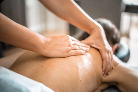 Deep tissue massage closeup view. Massage closeup with hands of professional masseur. Spa and job concept.の写真素材