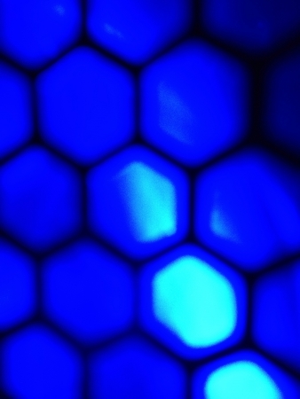 Zoom in on a blue led computer case fan on a honeycomb bezel の素材