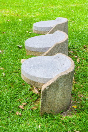 stone chair in green gardenの写真素材