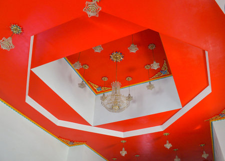 thai lamp on red ceilingの写真素材
