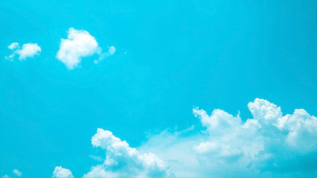 white fluffy clouds in the blue sky の写真素材