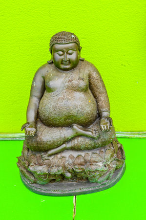 Buddha statue on green backgroundの写真素材