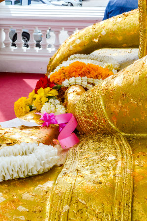 garland on gold hand buddha statueの写真素材