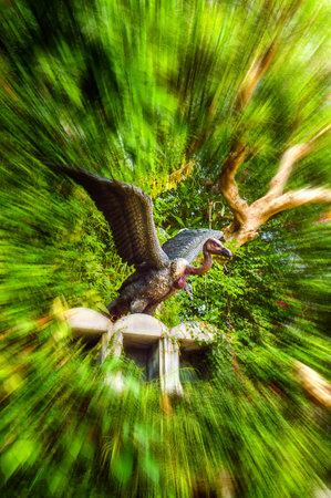 buzzard statue in gardenの写真素材