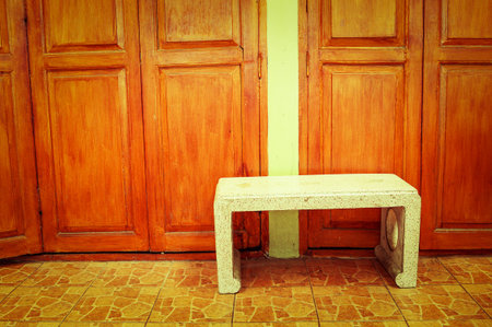 stone chair front wooden doorの写真素材