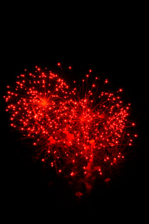 red fireworks on dark skyの写真素材