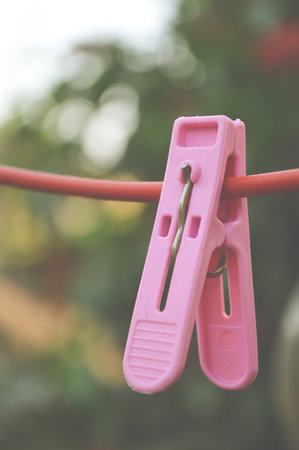 pink Clothes pin on red hangerの写真素材