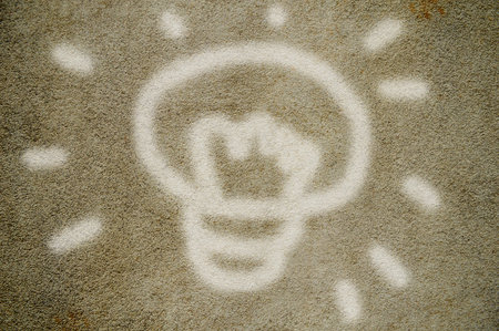 light bulb on cement wallの写真素材
